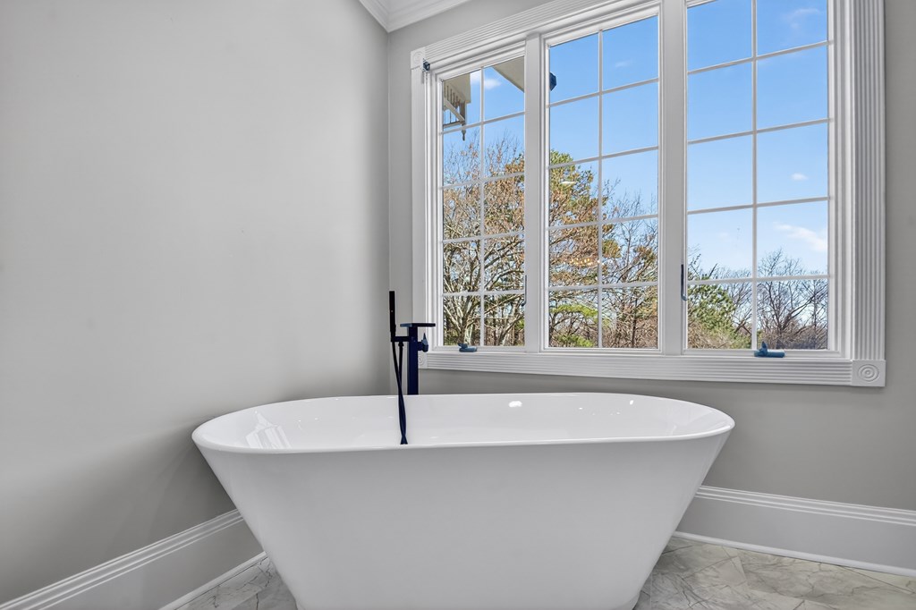 229 Crossroads Church Road Ellijay, GA 30540 - Photo 64 of 71 a white bath tub sitting in a bathroom next to a window