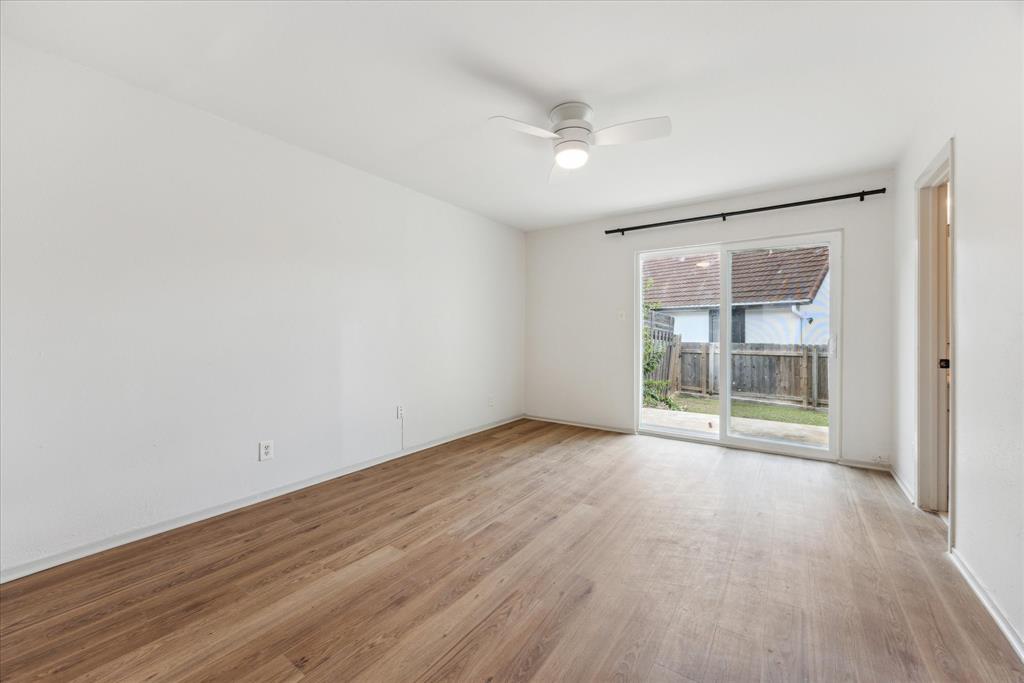 807 Castle Ridge Road, Unit A Austin, TX 78746 - Photo 10 of 15 Empty room featuring light wood-type flooring and a ceiling fan