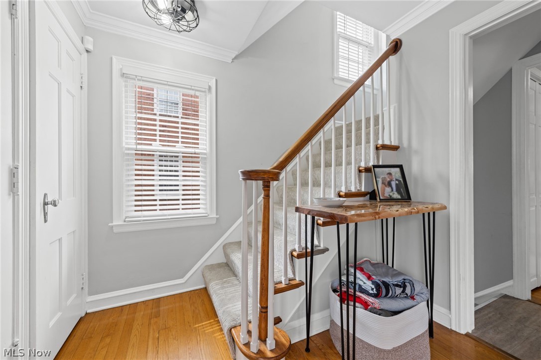 2368 Ashurst Road Cleveland, OH 44118 - Photo 9 of 20 Stairway with lofted ceiling, light wood-type flooring, and ornamental molding