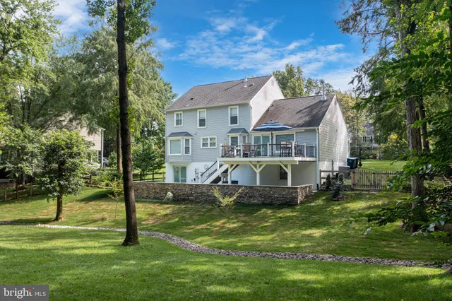 a view of a house with pool and chairs