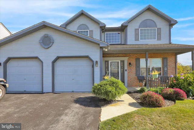 a front view of house with yard and glass windows