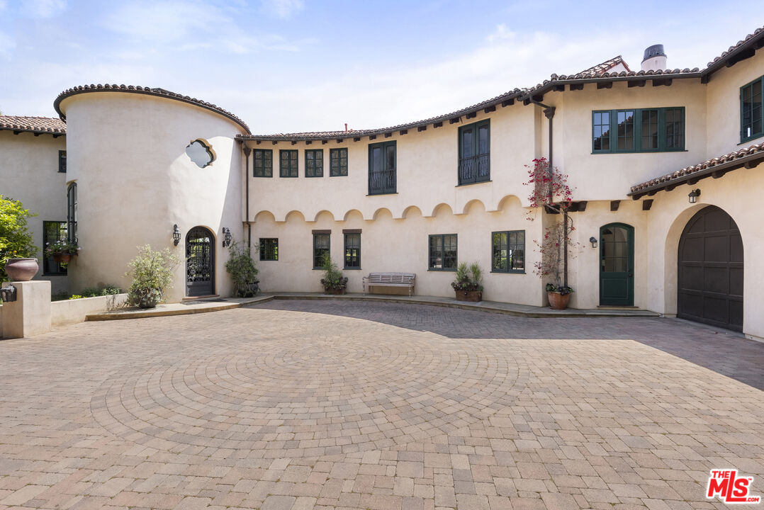 361 Fordyce Road Los Angeles, CA 90049 - Photo 2 of 40 a front view of a house with a road