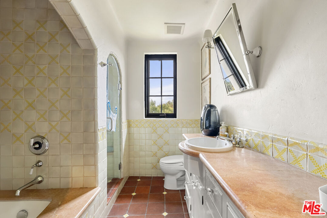 361 Fordyce Road Los Angeles, CA 90049 - Photo 22 of 40 a bathroom with a granite countertop sink a toilet and shower