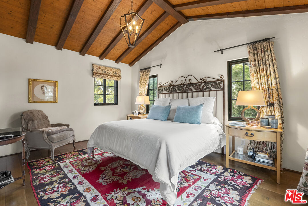 361 Fordyce Road Los Angeles, CA 90049 - Photo 25 of 40 a bedroom with a bed and wooden floor