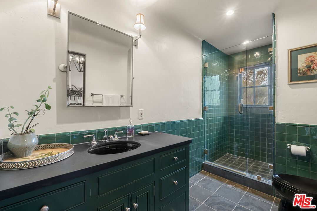 361 Fordyce Road Los Angeles, CA 90049 - Photo 26 of 40 a bathroom with a sink a mirror and a shower