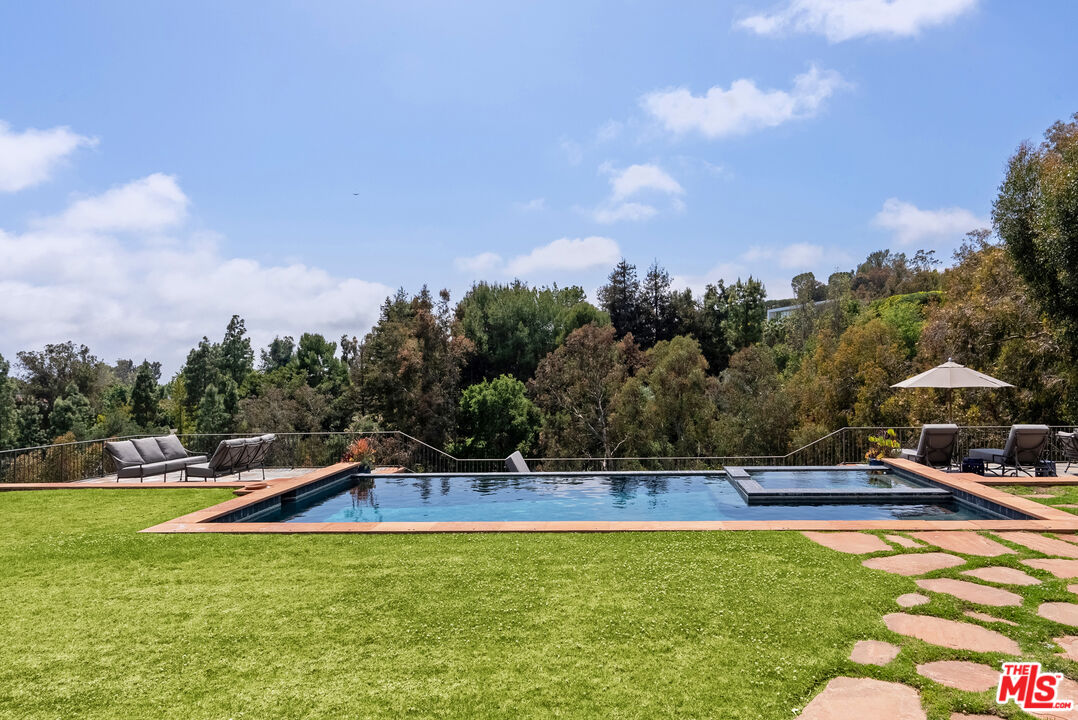 361 Fordyce Road Los Angeles, CA 90049 - Photo 30 of 40 a view of swimming pool with lawn chairs and plants