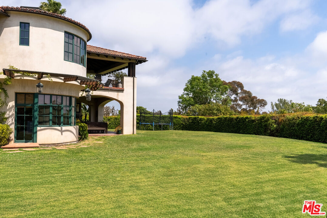 361 Fordyce Road Los Angeles, CA 90049 - Photo 34 of 40 a view of a house with a yard and sitting area