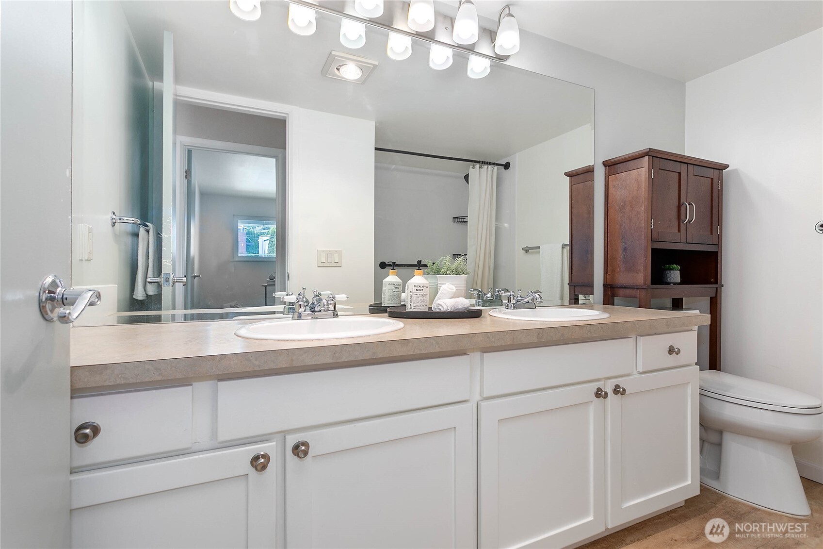 1014 11th Street, Unit 302 Bellingham, WA 98225 - Photo 15 of 30 a bathroom with a sink a toilet and a mirror