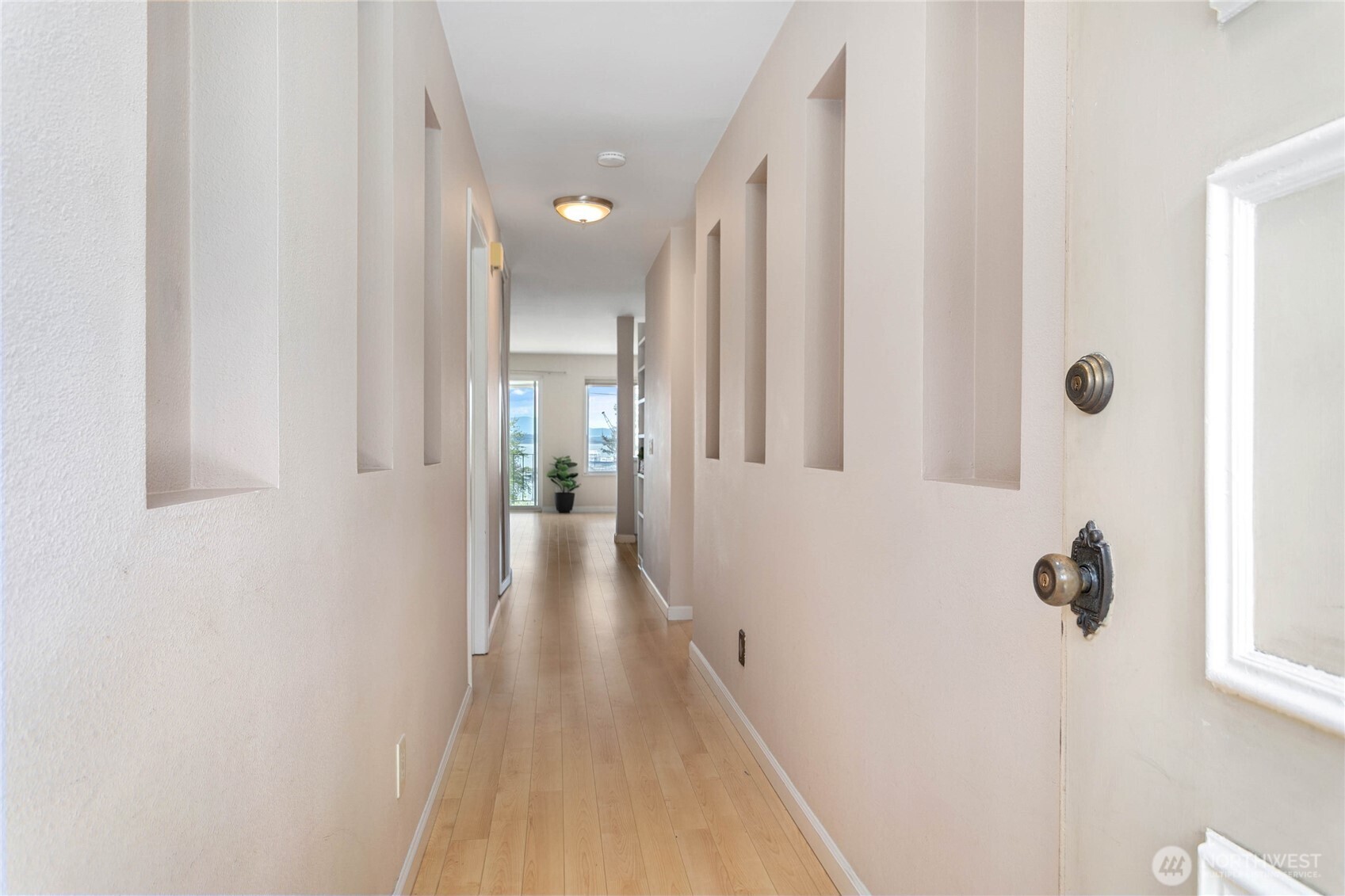 1014 11th Street, Unit 302 Bellingham, WA 98225 - Photo 8 of 30 a view of a hallway with wooden floor and staircase