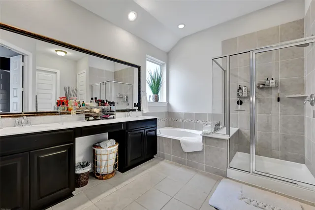 a bathroom with a double vanity sink toilet and shower