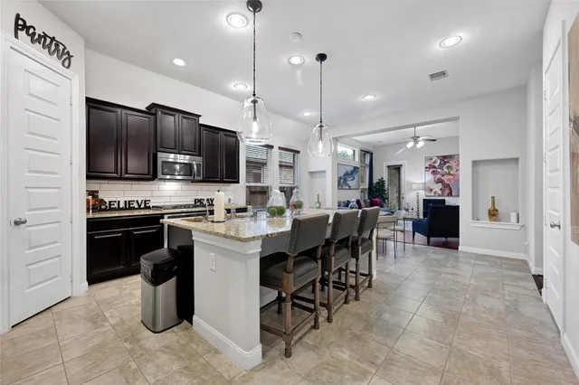 a large kitchen with a large counter top appliances and cabinets