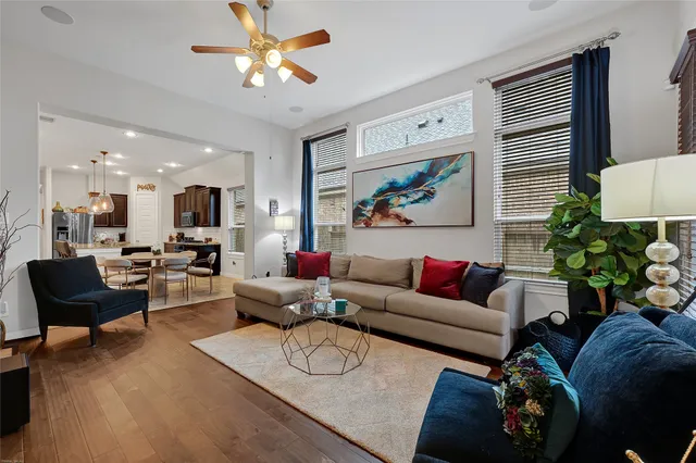 a living room with furniture potted plant and a window