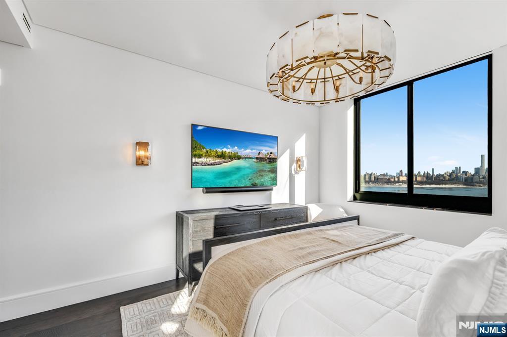 8701 Churchill Road, Unit PH1501 North Bergen, NJ 07047 - Photo 20 of 50 a bedroom with a bed and a flat screen tv