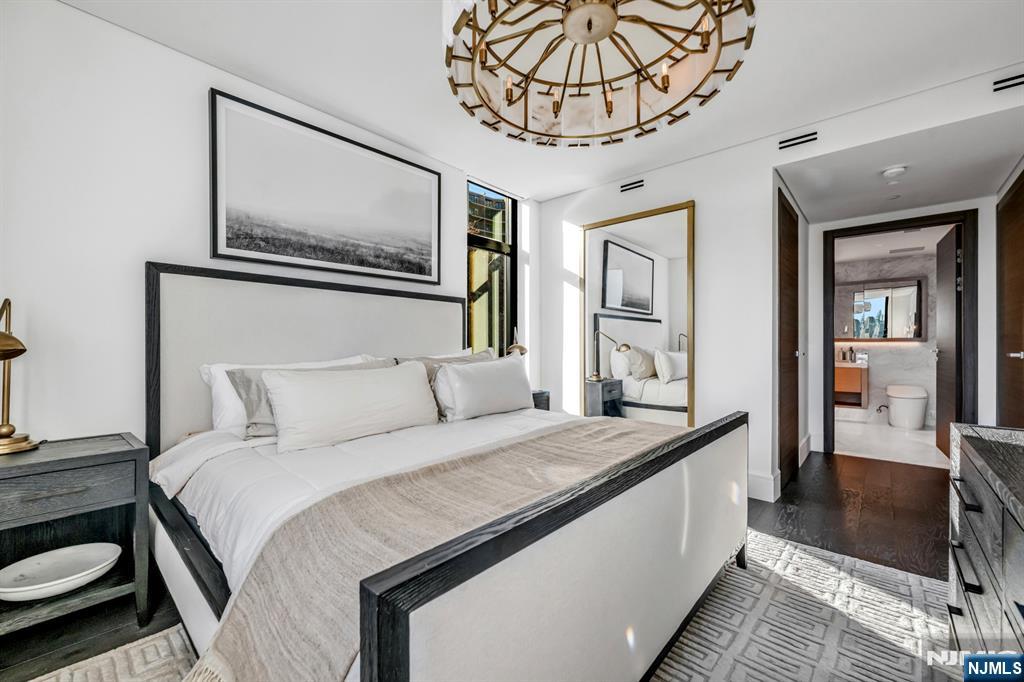 8701 Churchill Road, Unit PH1501 North Bergen, NJ 07047 - Photo 24 of 50 a bedroom with a large bed and a chandelier