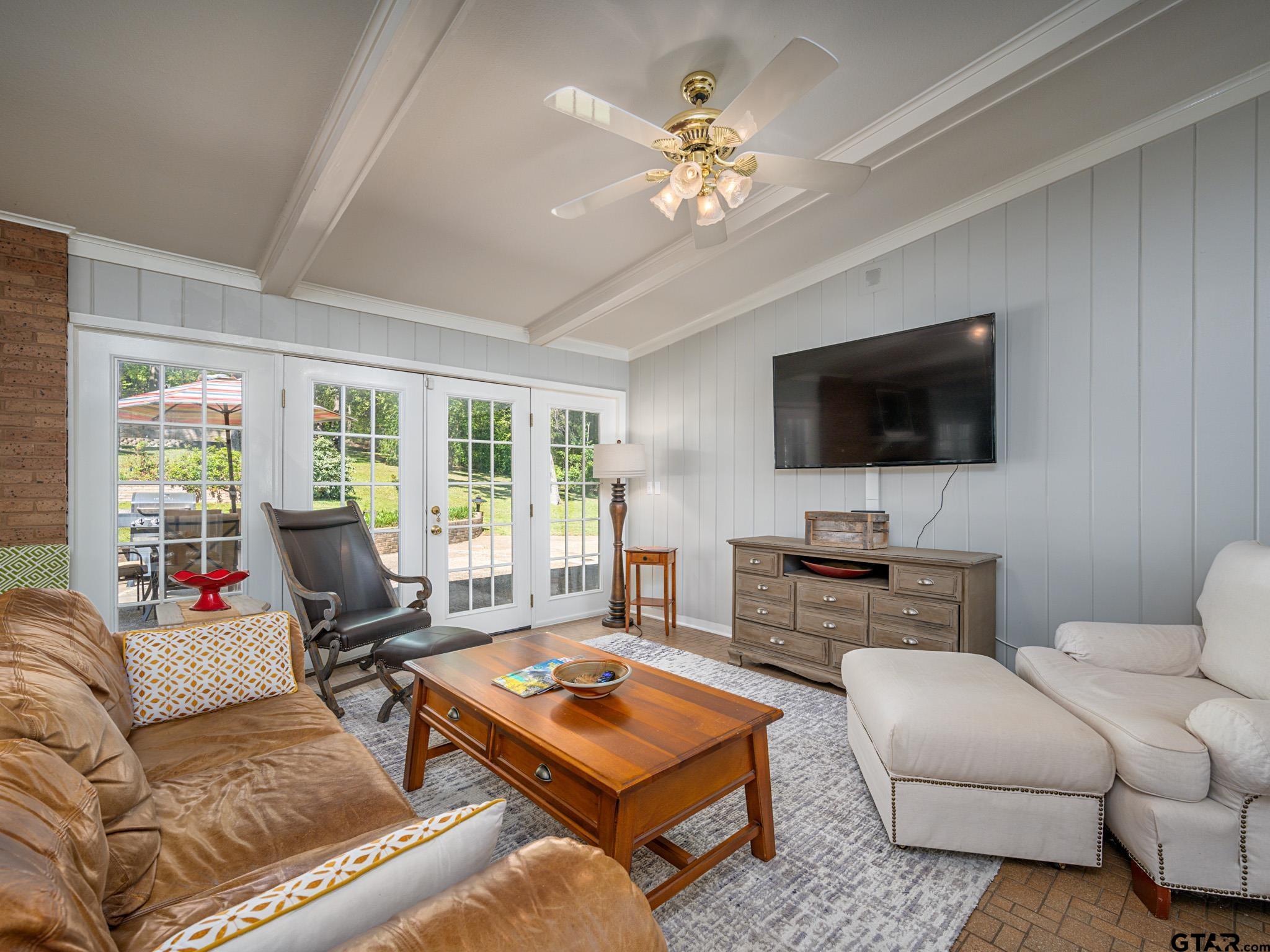 3203 Dinah Lane Tyler, TX 75701 - Photo 14 of 33 a living room with furniture a flat screen tv and a chandelier