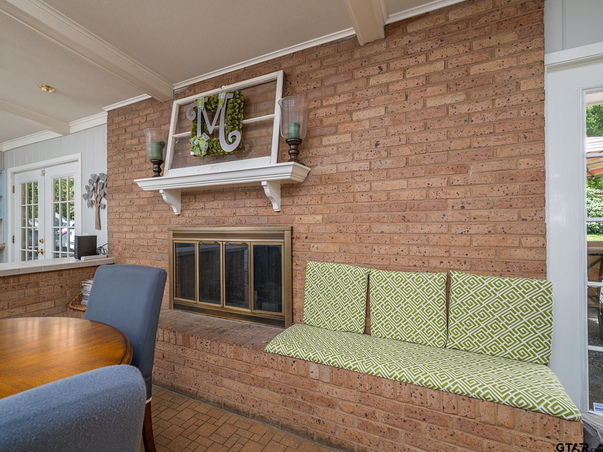3203 Dinah Lane Tyler, TX 75701 - Photo 15 of 33 a living room with a fireplace and a floor to ceiling window