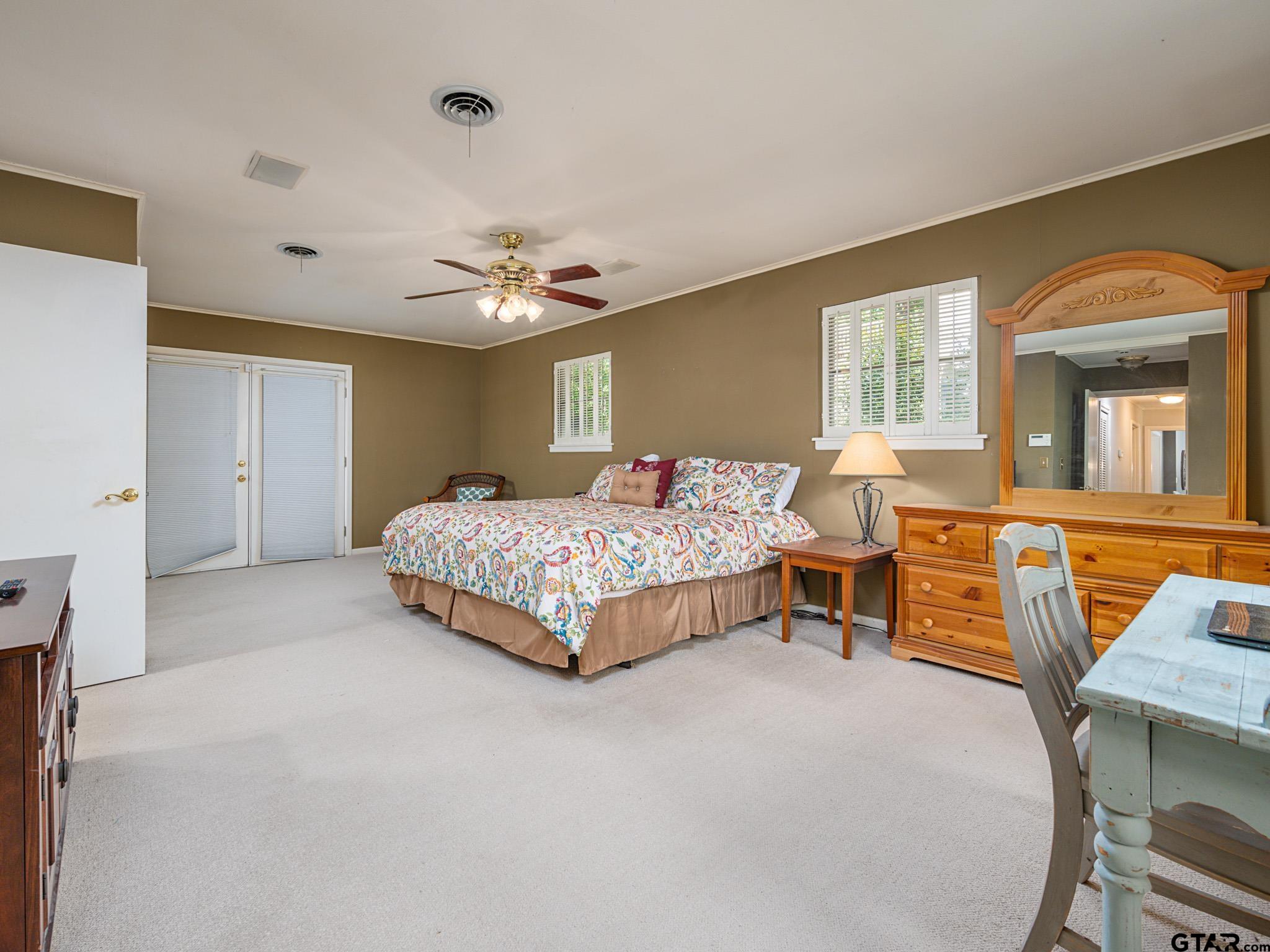 3203 Dinah Lane Tyler, TX 75701 - Photo 17 of 33 a bedroom with a bed a table and chair