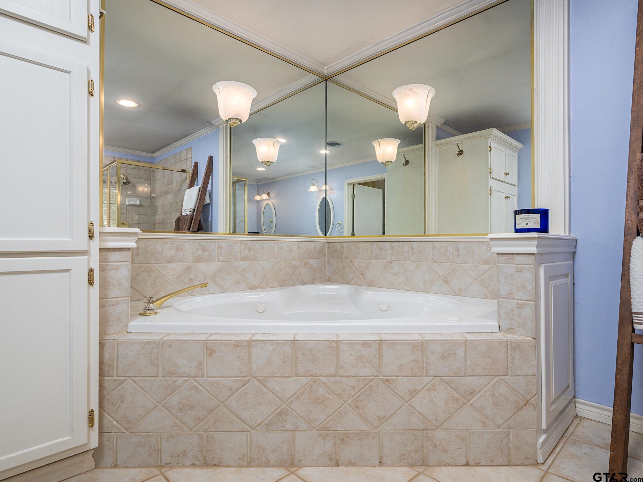3203 Dinah Lane Tyler, TX 75701 - Photo 20 of 33 a bathroom with a sink a large mirror and vanity