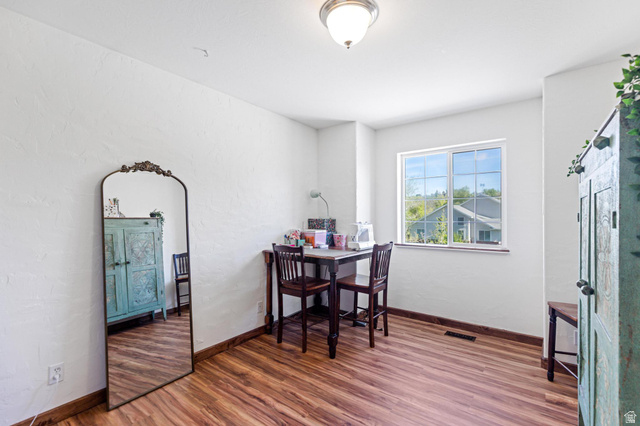814 Mountain Road Logan, UT 84321 - Photo 17 of 42 Room with wood-finish flooring, white painted walls, and a single window with grids