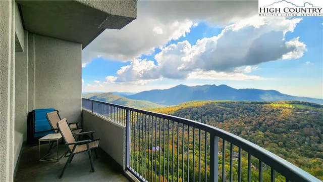 a view of a balcony with chair and wooden floor