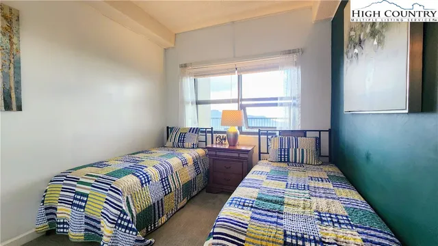 a bed sitting in a bedroom next to a window