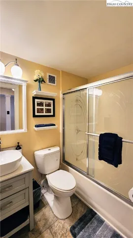 a bathroom with a toilet a sink and shower