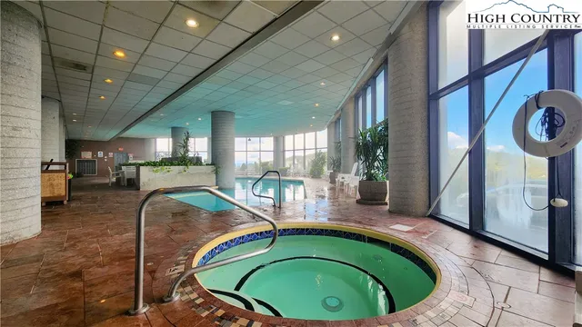 a swimming pool with outdoor seating and yard