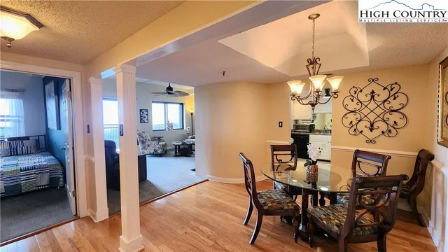 a view of a dining room with furniture and wooden floor