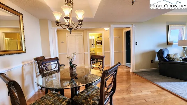 a view of a dining room with furniture and chandelier