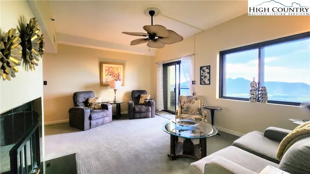 a living room with furniture a window and a chandelier