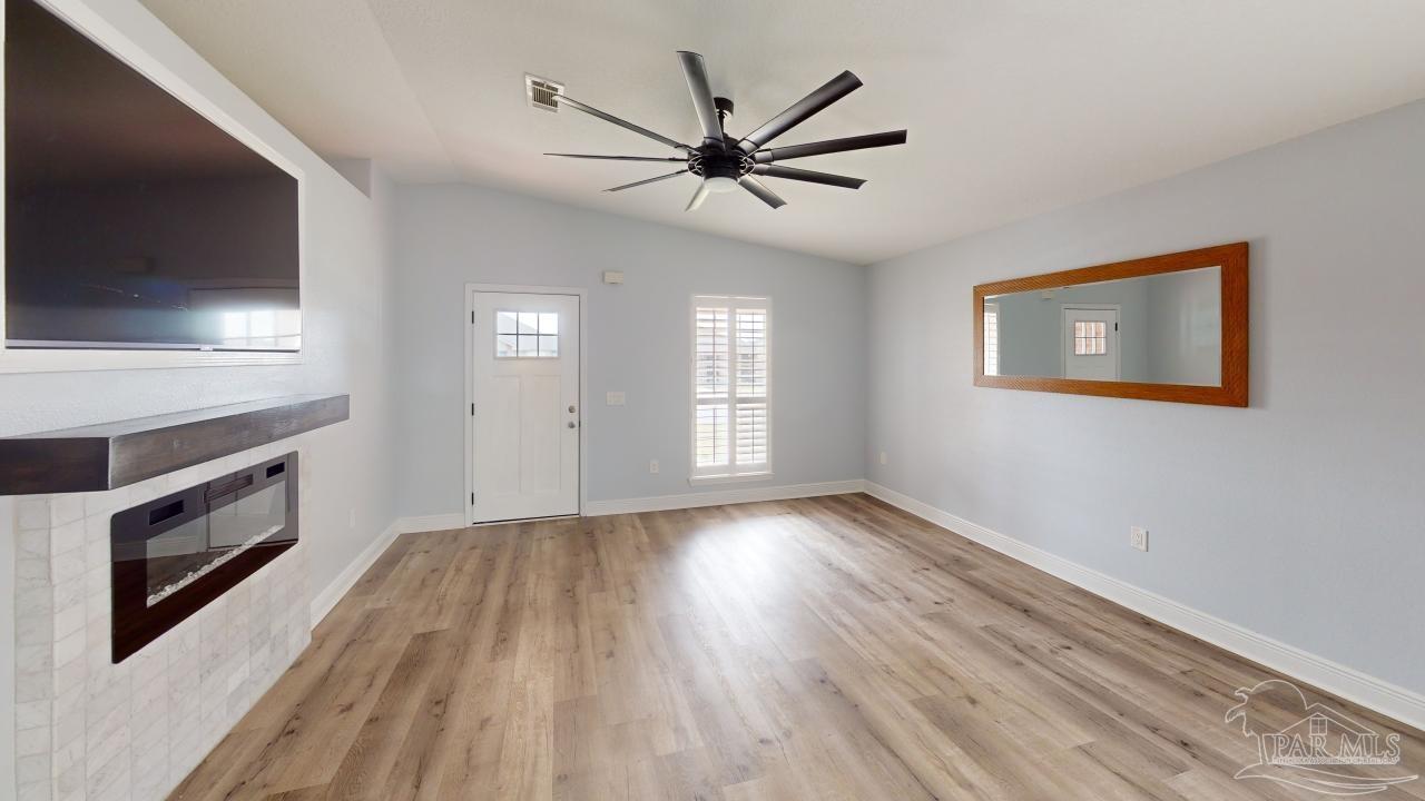 4730 Ashley Pl Boulevard Pace, FL 32571 - Photo 2 of 13 a view of empty room with wooden floor and fan