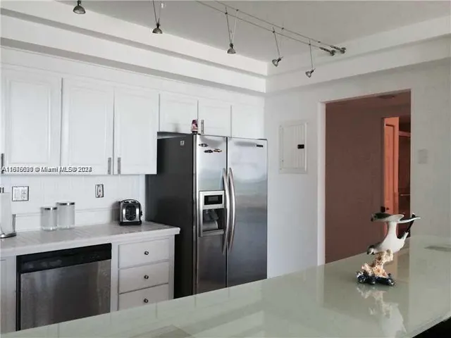 a kitchen with refrigerator cabinets and stainless steel appliances
