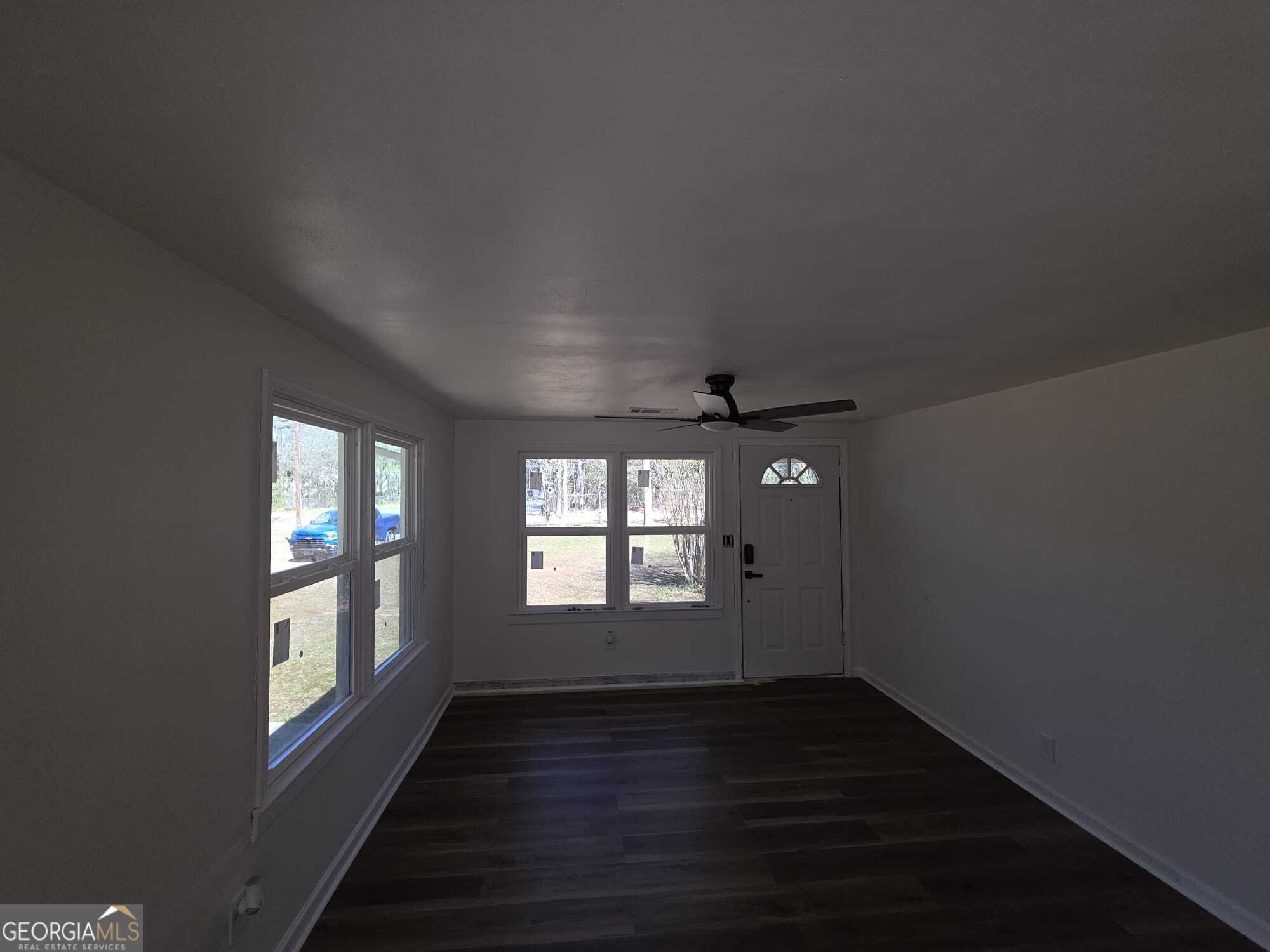 15 Dixie Drive Stockbridge, GA 30281 - Photo 11 of 19 an empty room with wooden floor and windows