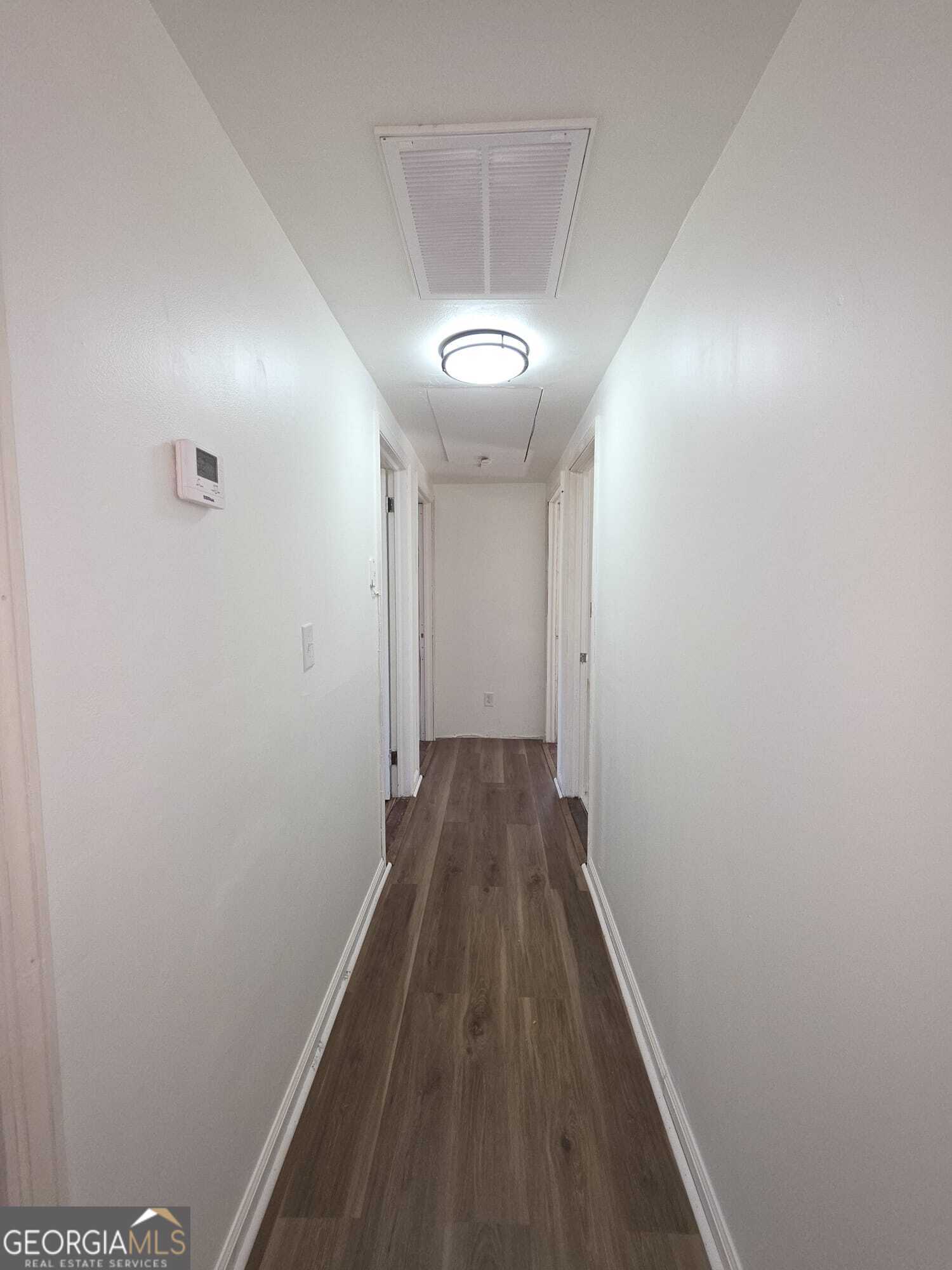 15 Dixie Drive Stockbridge, GA 30281 - Photo 14 of 36 a view of a hallway with wooden floor