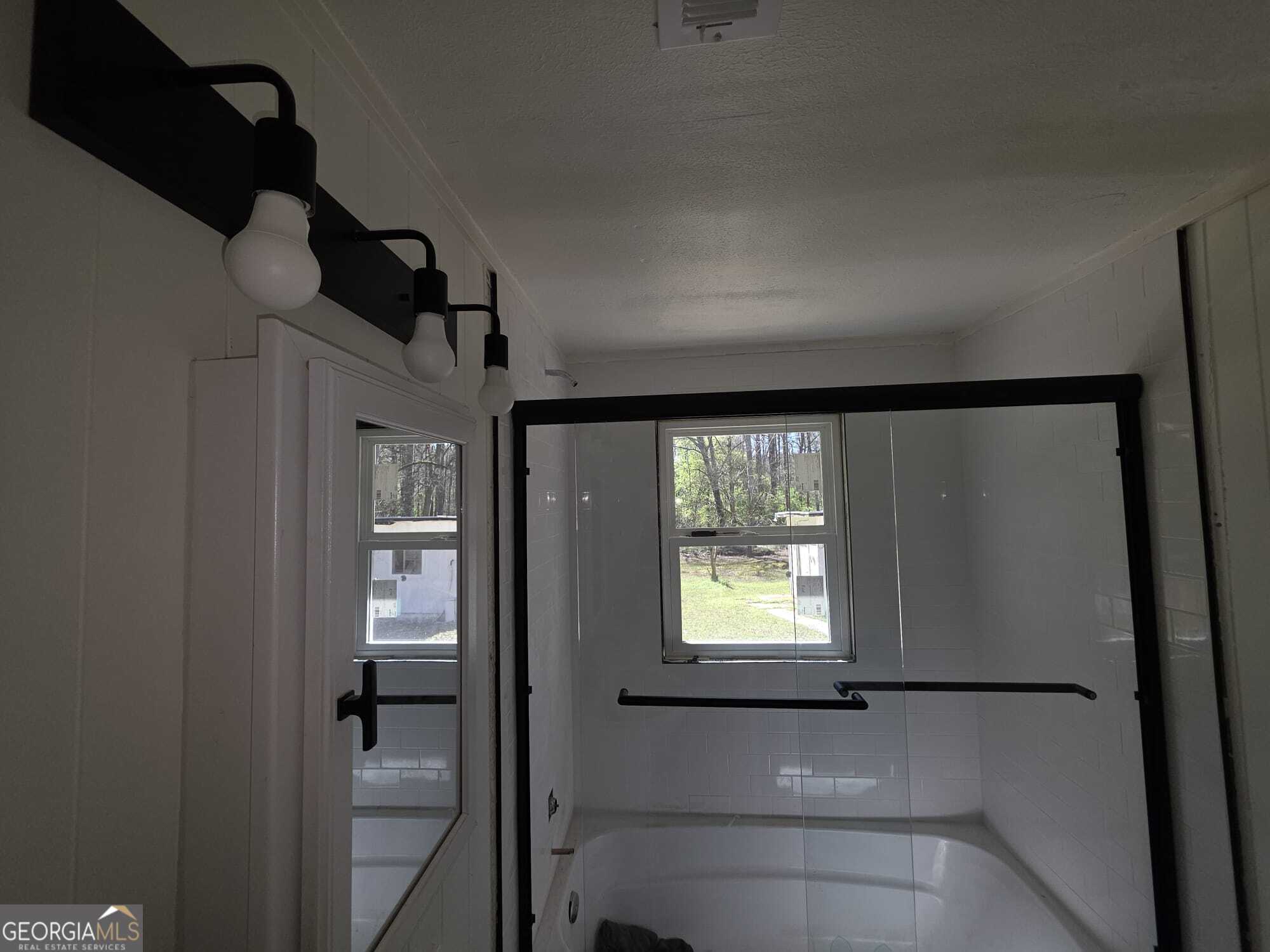 15 Dixie Drive Stockbridge, GA 30281 - Photo 15 of 19 a bathroom with a window and a shower
