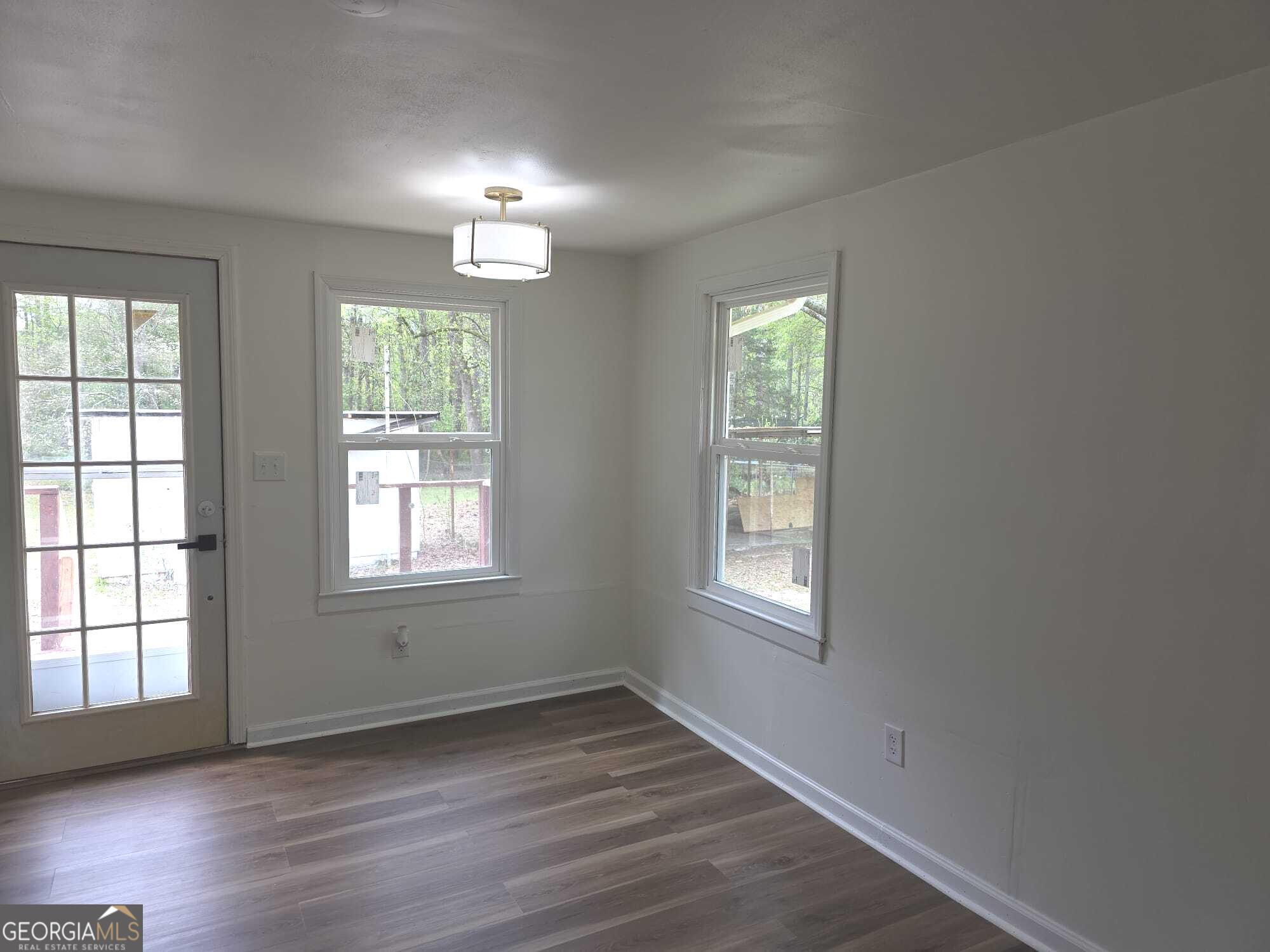 15 Dixie Drive Stockbridge, GA 30281 - Photo 20 of 36 a view of an empty room with wooden floor and a window