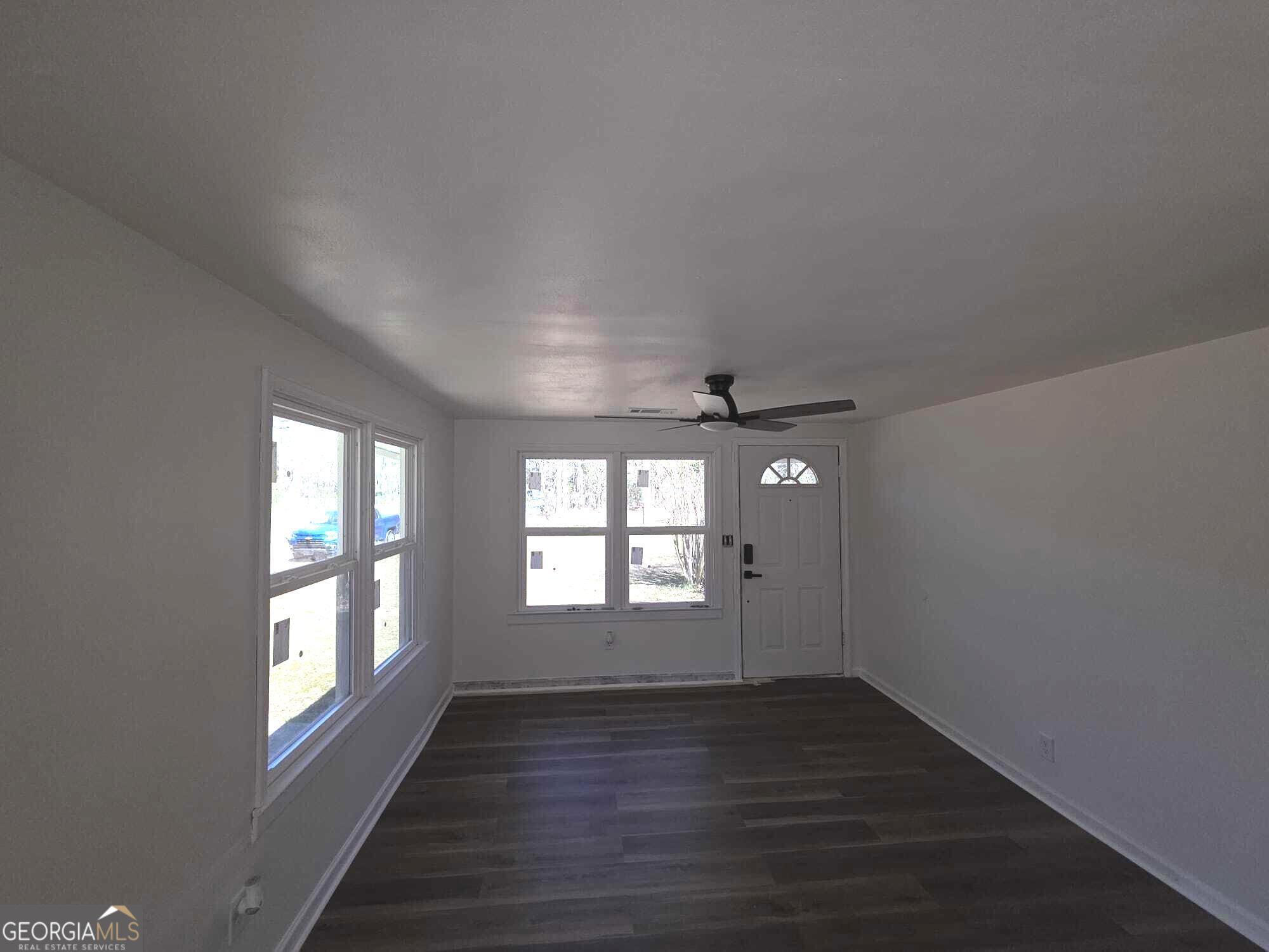 15 Dixie Drive Stockbridge, GA 30281 - Photo 22 of 36 an empty room with wooden floor and windows