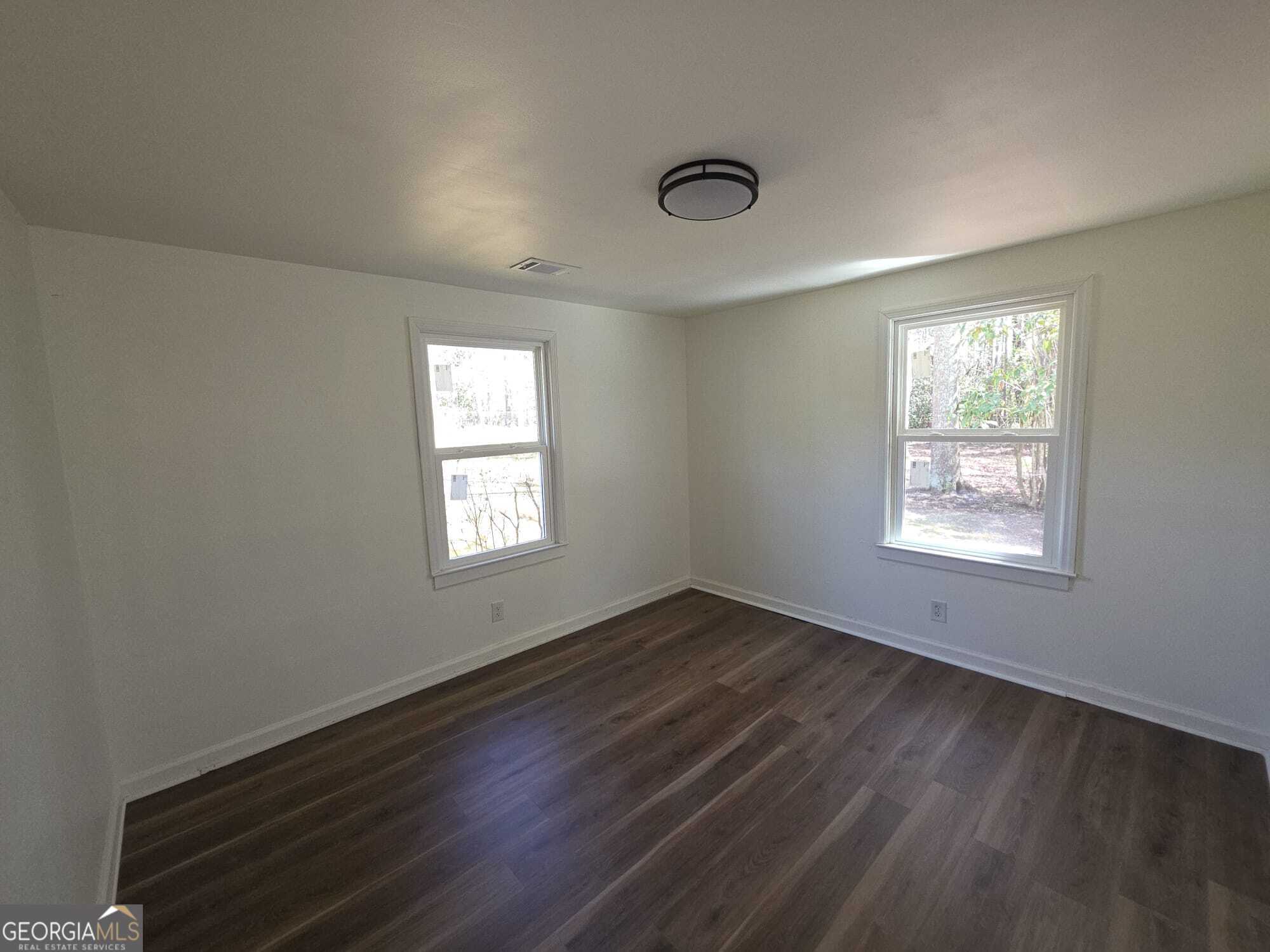 15 Dixie Drive Stockbridge, GA 30281 - Photo 34 of 36 a view of an empty room with wooden floor and a window