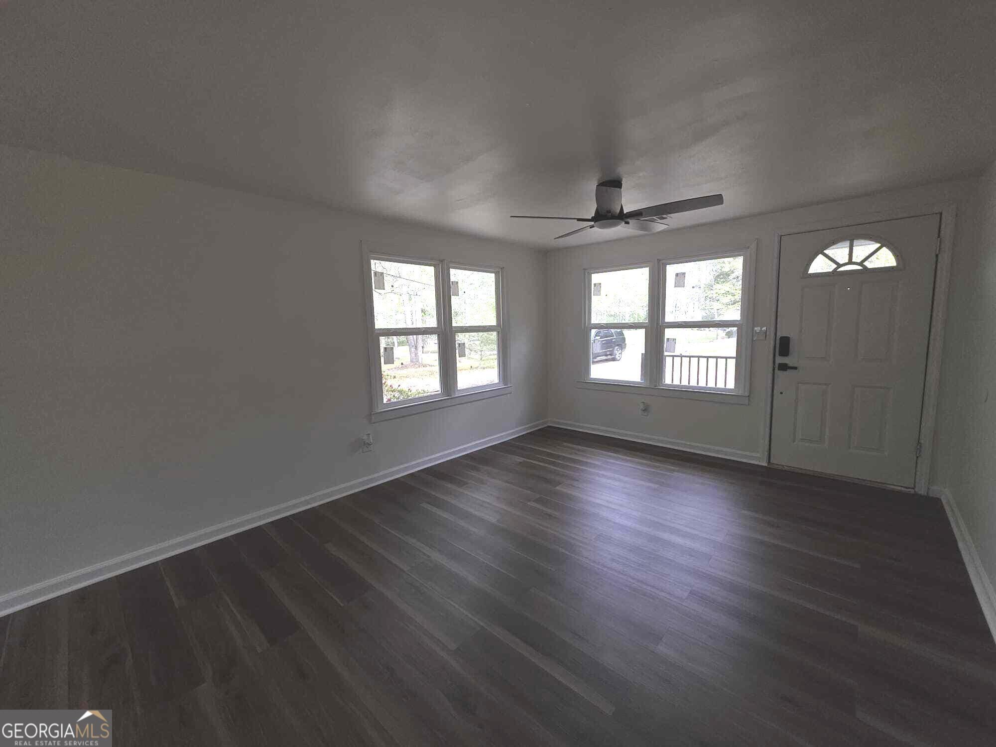 15 Dixie Drive Stockbridge, GA 30281 - Photo 5 of 36 an empty room with wooden floor and windows