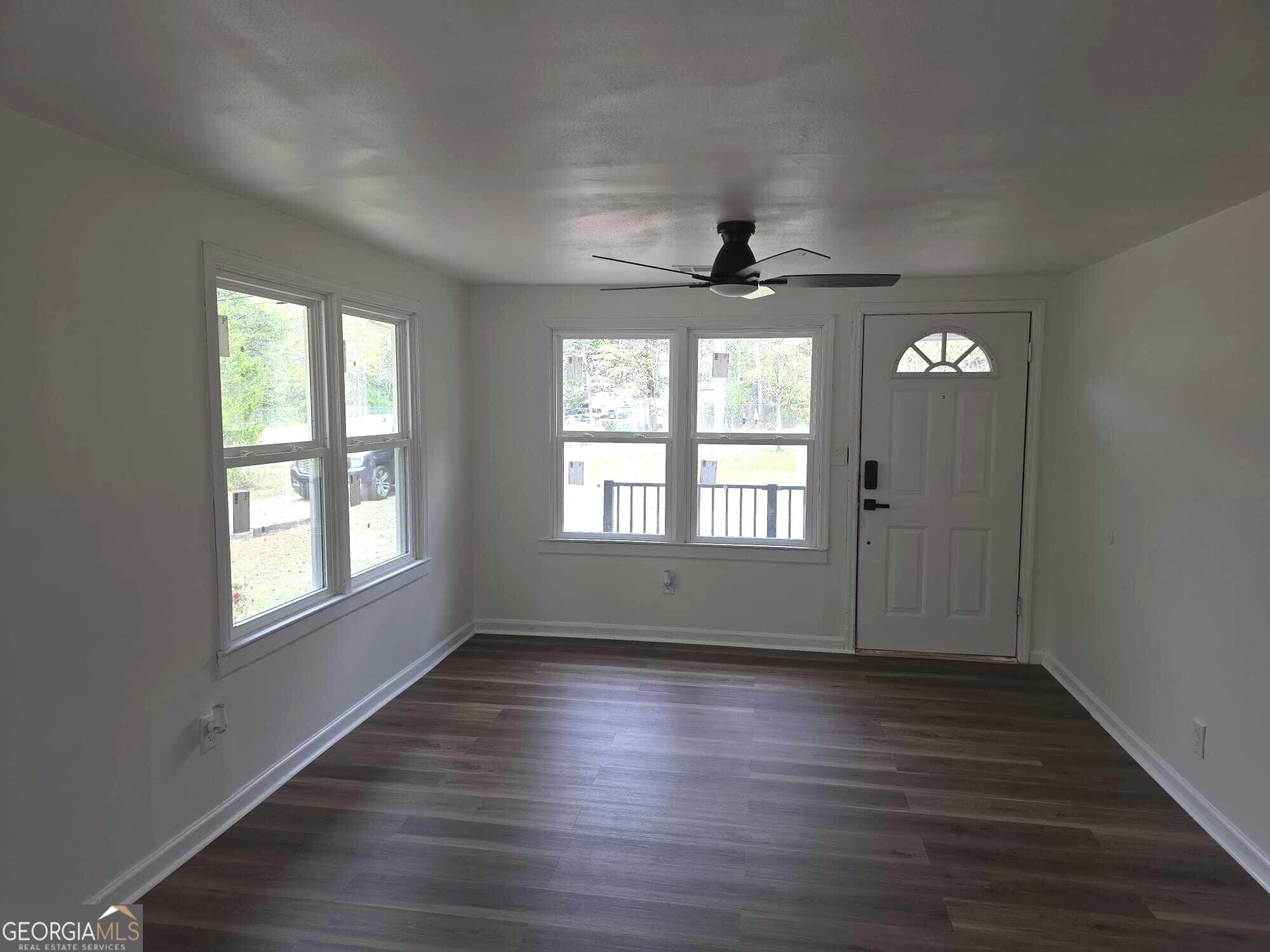 15 Dixie Drive Stockbridge, GA 30281 - Photo 7 of 36 an empty room with wooden floor and windows