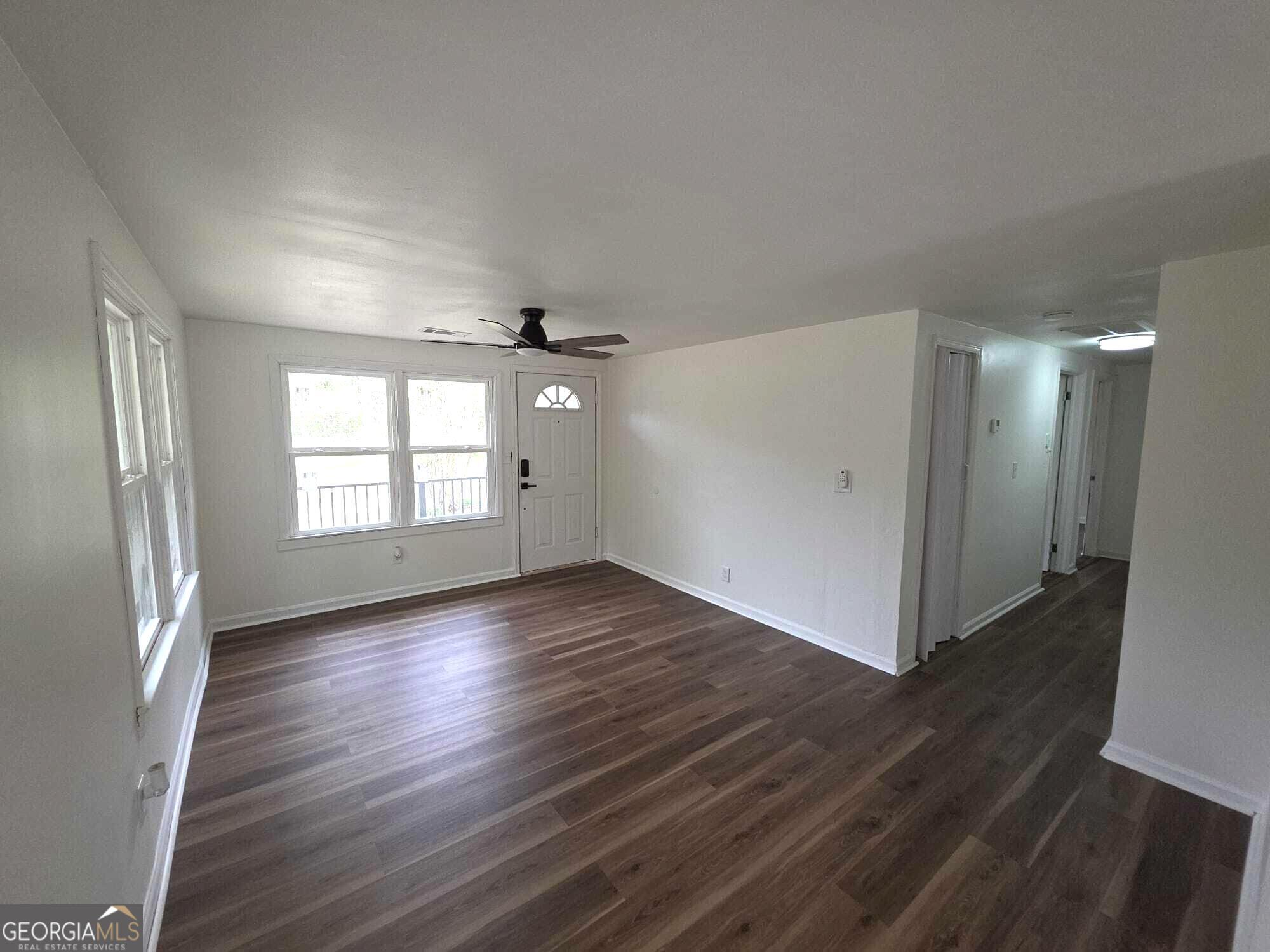 15 Dixie Drive Stockbridge, GA 30281 - Photo 9 of 36 an empty room with wooden floor and windows