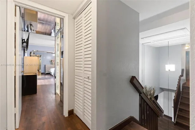 a view of a hallway with furniture and wooden floor