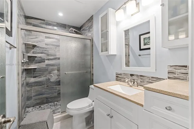 a bathroom with a sink toilet and shower