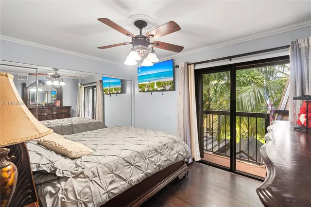 a bedroom with a large bed and a large window with the view of balcony