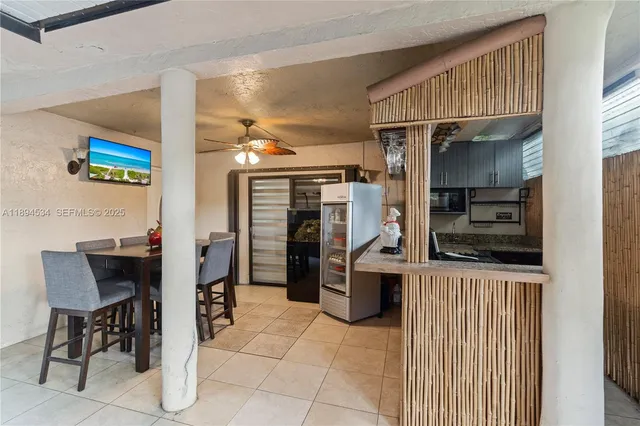a kitchen with stainless steel appliances kitchen island granite countertop a refrigerator and a stove
