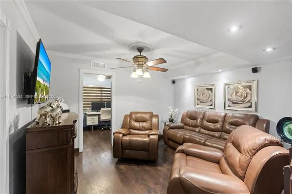 a living room with furniture flowerpot and a window