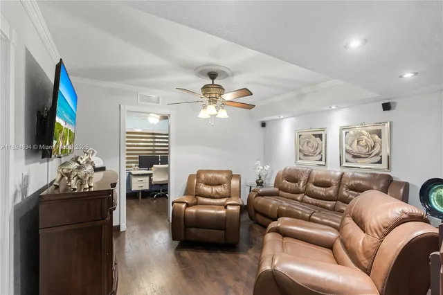 a living room with furniture flowerpot and a window