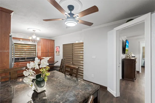 a dining room with furniture and a chandelier