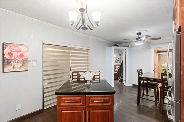 a view of a dining room with furniture wooden floor and chandelier