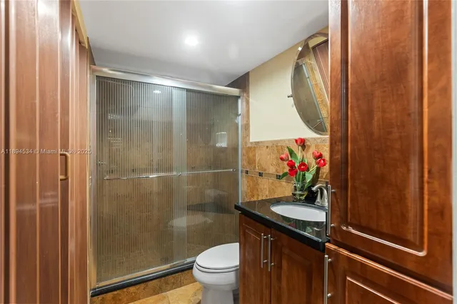 a bathroom with a sink toilet and shower